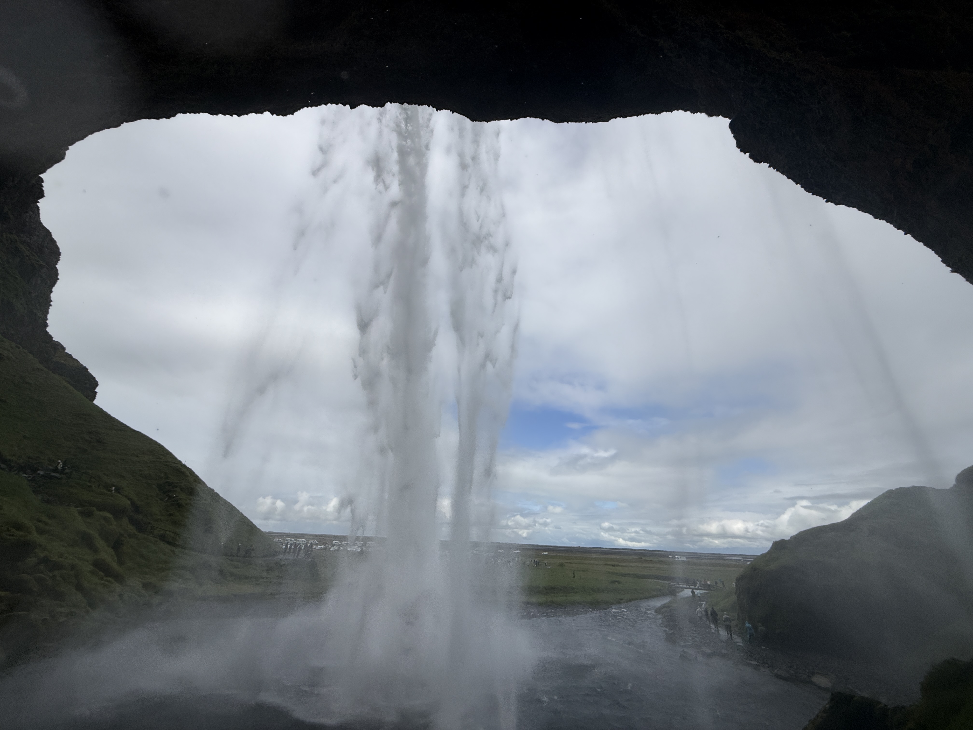 A waterfall viewed from behind on Iceland's South Coast